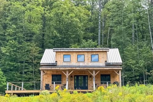 a wooden house with a metal roof at The Hollow in Plymouth