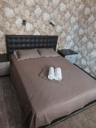 a bedroom with a bed with two towels on it at Апартаменти Іва в центрі на Набережній in Dnipro