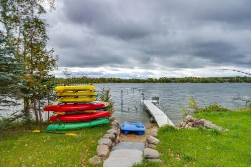 a group of boats are parked on a lake at Pequot Lakes Retreat with Beach and Fire Pit! in Pequot Lakes