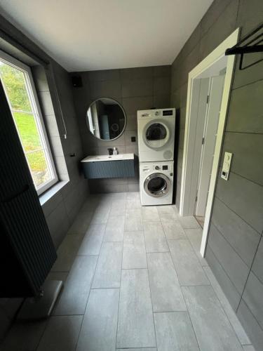 a laundry room with a washer and a washing machine at Husslåttene apartments with terrace in Skei 