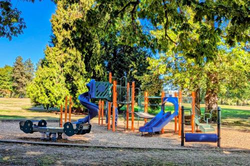 a playground in a park with a blue slide at Rosie’s Retro River Flat in Portland