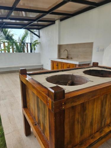 a kitchen with a wooden island with a sink at Ola dorada de Canoa in El Recreo