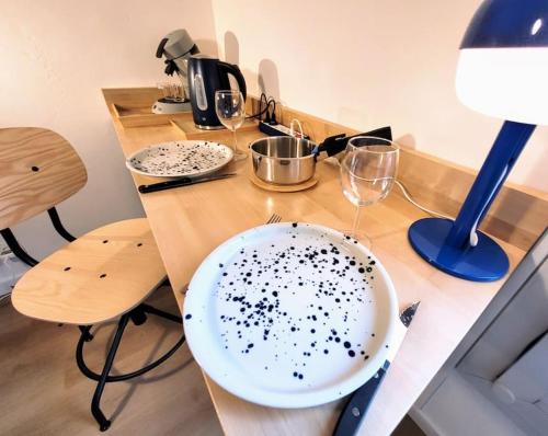 une table avec une plaque blanche avec des points noirs dans l'établissement Studio cosy, rénové, bien situé, parking privé, à Grenoble