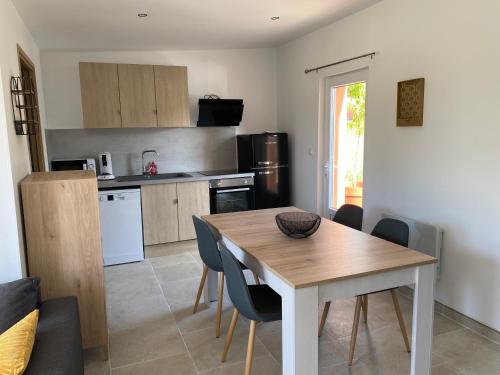 une cuisine et une salle à manger avec une table et des chaises dans l'établissement Un séjour à la ferme, à Sommery