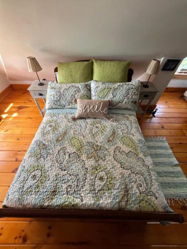 a large bed in a room with two lamps and a bed sidx sidx at The Lakeview Loft in Port Colborne
