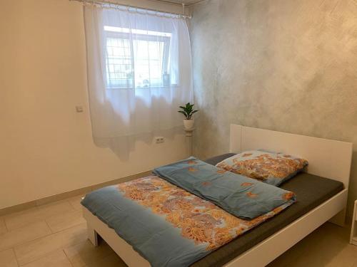 a bed with two pillows on it in a bedroom at Ferienwohnung Bangert in Idar-Oberstein