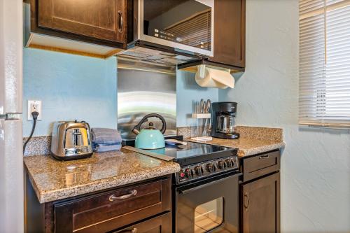 a kitchen with a stove and a tea kettle at Plantation Hale F5 in Kapaa