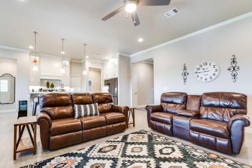 a living room with two leather couches and a rug at Texas Home with Hot Tub 3 Mi to Downtown Canyon! in Canyon