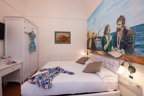 a bedroom with a large painting on the wall at ApartHotel Antica Repubblica in Amalfi center at 100mt from the sea in Amalfi