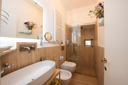 a bathroom with a tub and a toilet and a sink at ApartHotel Antica Repubblica in Amalfi center at 100mt from the sea in Amalfi