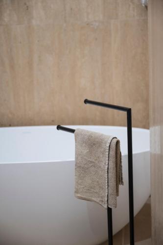 a towel hanging on a bath tub in a bathroom at ApartHotel Antica Repubblica in Amalfi center at 100mt from the sea in Amalfi