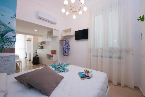 a living room with a bed and a chandelier at ApartHotel Antica Repubblica in Amalfi center at 100mt from the sea in Amalfi