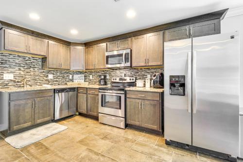 a kitchen with wooden cabinets and stainless steel appliances at Chattanooga House with Grill 12 Mi to Downtown! in Chattanooga