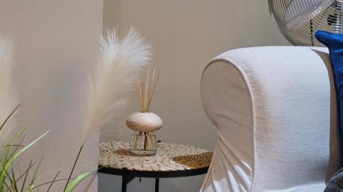 a table with a vase with feathers on it at Stylish 2 Bedroom Apartment, Leeds Centre + Free Parking in Leeds