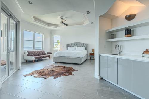 a kitchen and a living room with a bed in a room at Breathtaking 6BD Riverfront Mansion w Pool in Cape Coral