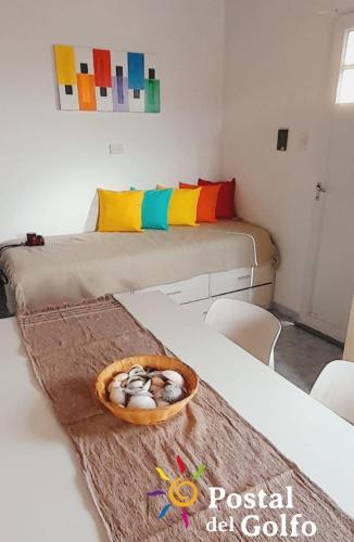 a room with two beds and a bowl of eggs on a table at Postal del Golfo in Las Grutas