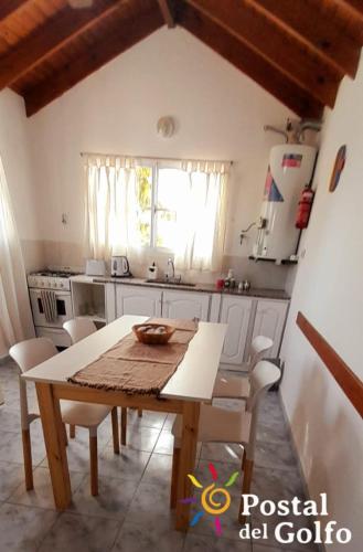a kitchen with a table and chairs in a room at Postal del Golfo in Las Grutas