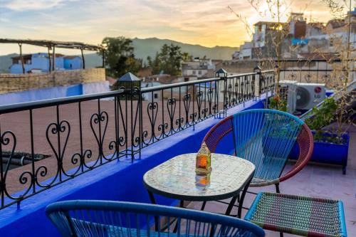 a table and chairs on top of a balcony at Iguana Azul in Chefchaouene