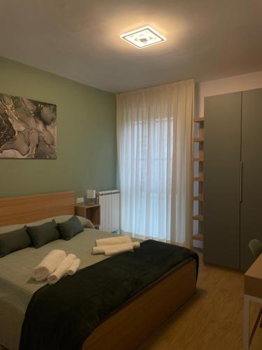 a bedroom with a bed with two towels on it at Coccinella Verde in Pisa