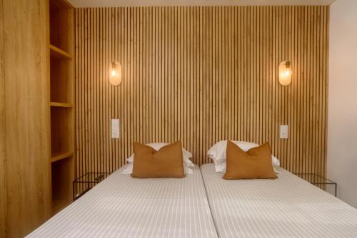 a bedroom with a large bed with two pillows at Residencial Fortunato in Ericeira