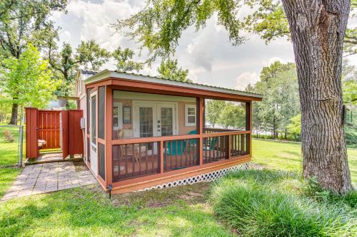a gazebo with a deck next to a tree at Lake Holbrook Waterfront Vacation Rental with Dock! in Mineola