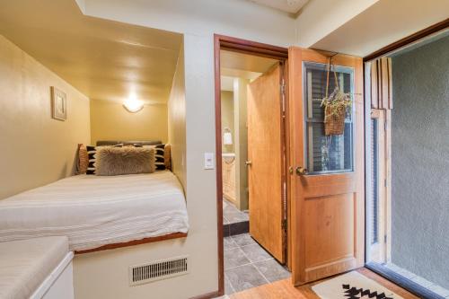a small bedroom with a bed and a door at Spire Chalet at Alpine Meadows - 4BR W Hot Tub and Ski Shuttle in Alpine Meadows