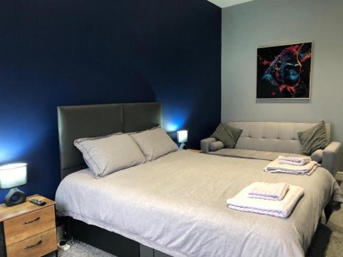 a bedroom with a large bed with two towels on it at Affordable Luxury 1 Stunning apartment Sunderland close to City centre hospital Crown Works Studio and Nissan in Sunderland