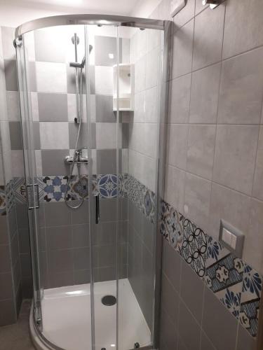 a shower with a glass door in a bathroom at Sapore di Sale - Casa Vacanza a Pizzo Calabro in Pizzo