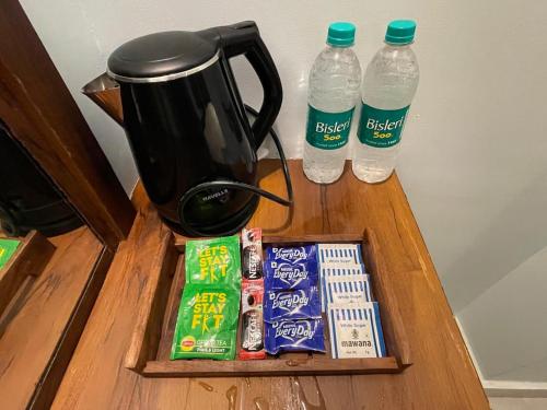 a table with two bottles of water and snacks at BLUE ANGEL Guest House in Shillong