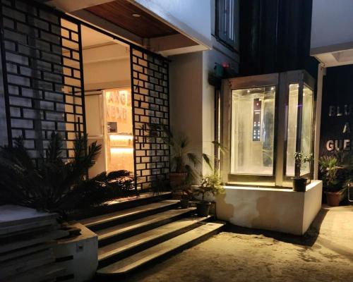a store front with stairs and a window at night at BLUE ANGEL Guest House in Shillong