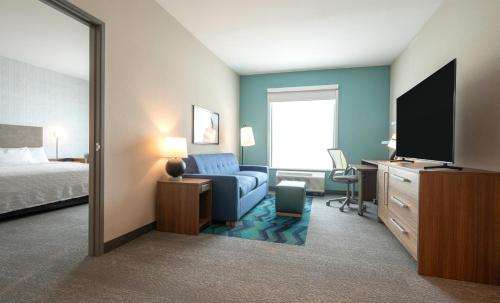 a hotel room with a bed and a television at Home2 Suites by Hilton Fort Walton Beach Eglin AirForce Base in Fort Walton Beach
