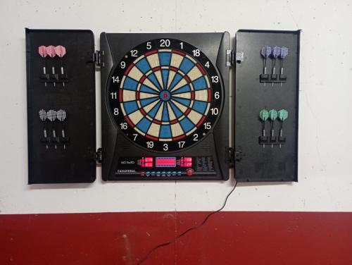 a dart board is attached to a wall at Casa La Parra en Teruel in Villastar