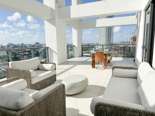 a balcony with couches and a view of a city at Private Terrace in Luxury 3BR Condo in Brickell in Miami