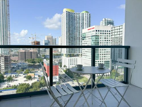 a table and two chairs on a balcony with a view at Private Terrace in Luxury 3BR Condo in Brickell in Miami