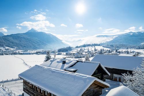 a snow covered roof of a building with mountains in the background at Chalet Aignerhof in Flachau
