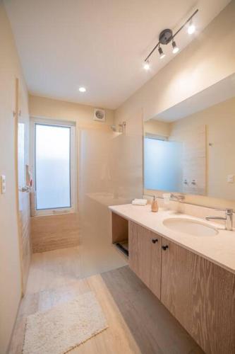 a bathroom with a sink and a mirror and a tub at papaya 15 Exclusive PentHouse with rooftop and jacuzzi in Playa del Carmen