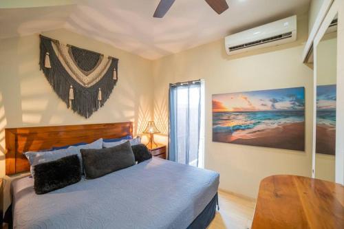 a bedroom with a bed and a table in it at papaya 15 Exclusive PentHouse with rooftop and jacuzzi in Playa del Carmen