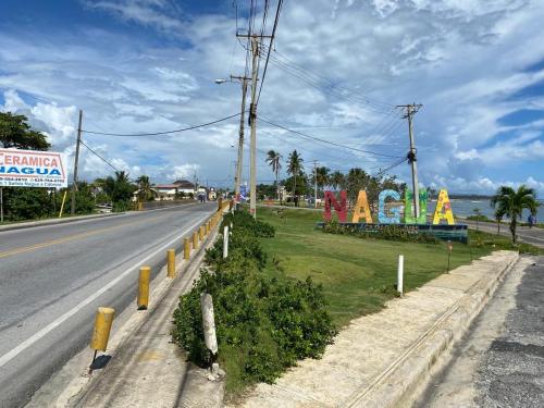 an empty road with a sign on the side of the road at Sunrise ApartaHotel in El Manguito