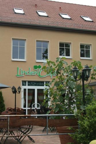 a building with a sign on the front of it at Lindencafe Luckenwalde in Luckenwalde