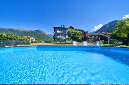 a large swimming pool in front of a house at Casa Onorio in Sorico