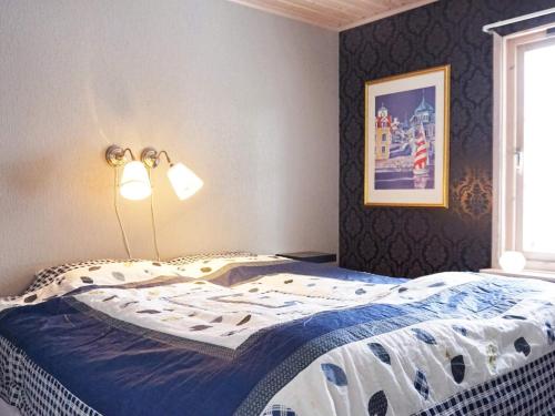 a bedroom with a bed with a lamp on it at 5 person holiday home in MUNKEDAL-By Traum in Munkedal