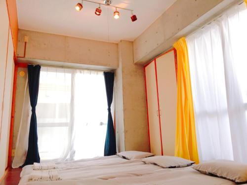 a bedroom with two beds and a window at Guest House Terrace Sakashita - Vacation STAY 46671v in Naha