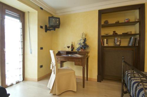 a room with a desk and a tv on a wall at Altavilla Locanda E Tipica Trattoria in Bianzone