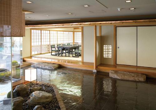 a dining room with a table in a building at Hotel Awina Osaka in Osaka