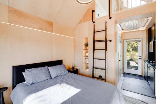 a bedroom in a tiny house with a bed at Bunkies- The Hold in Ottawa