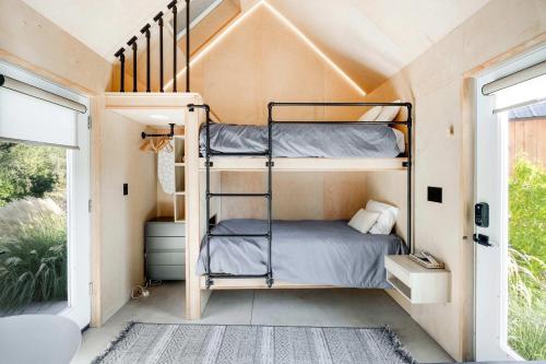 a bedroom with bunk beds in a tiny house at Bunkies- The Hold in Ottawa