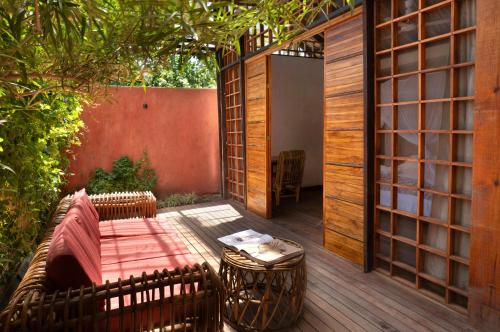 an outdoor patio with a table and a bench at Haku hotel in Palomino