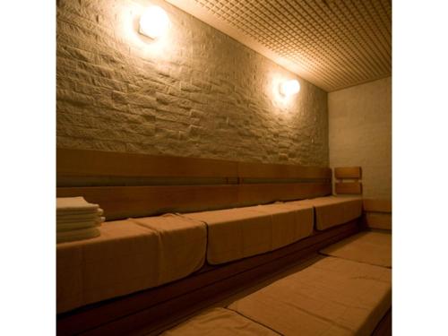 a row of benches in a room with a brick wall at Sansuien - Vacation STAY 06800v in Kochi