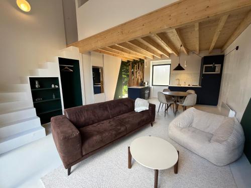 a living room with a couch and a table at Le Jardin Secret in Lohéac
