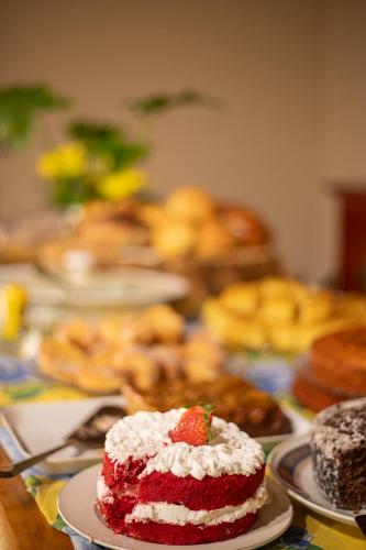 a red velvet cake with a strawberry on a table at Recanto dos Vianas in Teresópolis